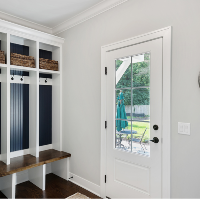 Minimalist mudroom with bench, hooks, and mirror.