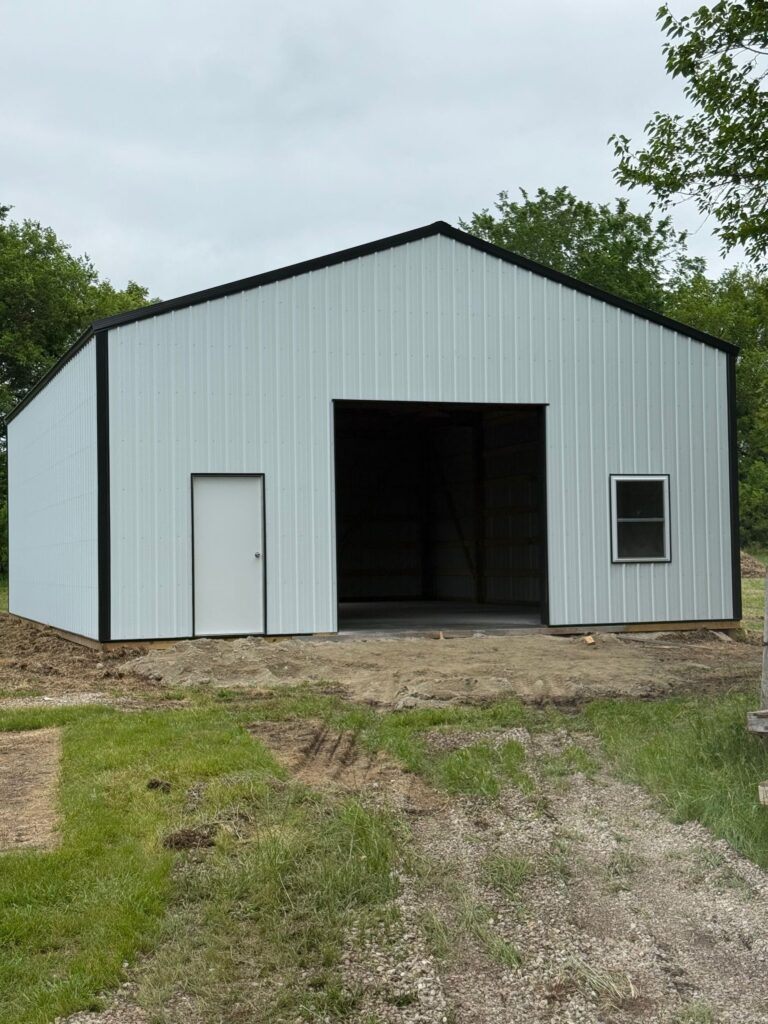 White metal warehouse building with open door